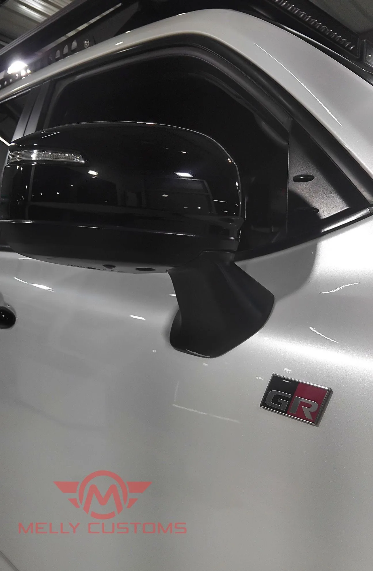 Close detail of the paint protection film edge on a white Toyota Land Cruiser